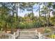 Scenic view of a serene lake surrounded by lush trees, as seen from a deck with white railings at 2824 Old Drake Dr, Seabrook Island, SC 29455