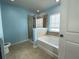 Bright bathroom featuring a walk-in shower, a soaking tub, and a window for natural light at 3072 Adventure Way, Ladson, SC 29456