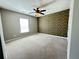 Comfortable carpeted bedroom with unique camo accent wall, ceiling fan, and natural light at 3072 Adventure Way, Ladson, SC 29456