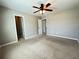 Spacious carpeted bedroom with ceiling fan and easy access to additional rooms at 3072 Adventure Way, Ladson, SC 29456