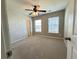 Carpeted bedroom with unique accent wall, ceiling fan, and bright natural light at 3072 Adventure Way, Ladson, SC 29456