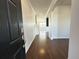View of the entryway showcasing hardwood floors and neutral walls leading into the home's living spaces at 3072 Adventure Way, Ladson, SC 29456