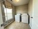 Convenient laundry room with washer, dryer, shelving, and a window for natural light at 3072 Adventure Way, Ladson, SC 29456