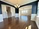 Open concept living room featuring hardwood floors, decorative lighting, and archways connecting to other rooms at 3072 Adventure Way, Ladson, SC 29456
