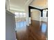 View of the living room showcasing hardwood floors, arched doorways, and natural light from multiple windows at 3072 Adventure Way, Ladson, SC 29456
