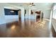 Open concept living space showcasing hardwood floors, dining area with modern light fixture, and lots of natural light at 3072 Adventure Way, Ladson, SC 29456
