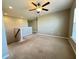Spacious carpeted loft featuring neutral walls, natural light, and a ceiling fan at 3072 Adventure Way, Ladson, SC 29456