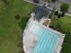Aerial shot of a community pool surrounded by lush landscaping and lounge chairs for relaxing by the water at 3072 Adventure Way, Ladson, SC 29456