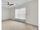 Bright, carpeted bedroom with a ceiling fan and large window with blinds at 315 Bradley Bend Dr, Moncks Corner, SC 29461