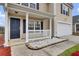 Inviting front porch with white railing and decorative stone accents, leading to a dark front door at 315 Bradley Bend Dr, Moncks Corner, SC 29461