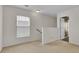 Neutral hallway with carpet, window, and white walls leading to rooms in this move-in-ready home at 315 Bradley Bend Dr, Moncks Corner, SC 29461