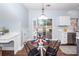 Bright dining space with a modern glass table, stylish chairs, and convenient access to the kitchen at 3388 Forest Glen Dr, Charleston, SC 29414