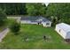 Aerial perspective of house on a green lawn with a garage and storage shed at 3657 Santee River Rd, Saint Stephen, SC 29479