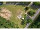 Top-down aerial showcases home, outbuilding, and expansive grassy lot, ready for new development at 3657 Santee River Rd, Saint Stephen, SC 29479
