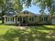 Quaint single story home with a covered front porch and a charming, symmetrical facade at 3657 Santee River Rd, Saint Stephen, SC 29479