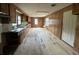 Spacious kitchen with wood paneling, featuring ample counter space, cabinets, and natural light at 3657 Santee River Rd, Saint Stephen, SC 29479
