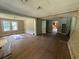 A potential-filled living room, showcasing hardwood floors and bright, natural light at 3657 Santee River Rd, Saint Stephen, SC 29479