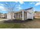 Rear view of home features a screened-in porch and well-maintained landscaping, enhancing outdoor enjoyment at 3933 Bessemer Rd, Mount Pleasant, SC 29466