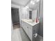 Bathroom with double vanity and marble floor and glass enclosed shower, exuding simple elegance at 3933 Bessemer Rd, Mount Pleasant, SC 29466