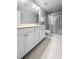Bright bathroom with marble tile features double vanity and glass enclosed shower for a relaxing and functional space at 3933 Bessemer Rd, Mount Pleasant, SC 29466