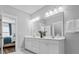 Bright bathroom featuring a large mirror, double vanity, and views into main bedroom at 3933 Bessemer Rd, Mount Pleasant, SC 29466