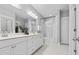 Bright bathroom showcasing double vanity, large mirror, and shower-tub combination at 3933 Bessemer Rd, Mount Pleasant, SC 29466
