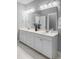 Bathroom featuring dual sinks with white cabinetry, large mirror, and updated fixtures at 3933 Bessemer Rd, Mount Pleasant, SC 29466