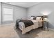 Cozy bedroom with a large window, soft carpet, and neutral decor features a comfortable-looking bed at 3933 Bessemer Rd, Mount Pleasant, SC 29466