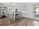 Well-lit dining area features an elegant table, seating for six, and a large window for plenty of natural light at 3933 Bessemer Rd, Mount Pleasant, SC 29466