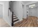 Welcoming entryway with hardwood floors, staircase, and modern lighting at 3933 Bessemer Rd, Mount Pleasant, SC 29466