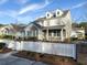 Charming two-story home with brick accents, dormer windows and a welcoming front porch, framed by a white picket fence at 3933 Bessemer Rd, Mount Pleasant, SC 29466