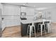 Spacious kitchen with quartz counters, stainless appliances, island seating, and wood-look flooring at 3933 Bessemer Rd, Mount Pleasant, SC 29466