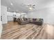 Open-concept living room featuring hardwood floors, ceiling fan, and tons of natural light at 3933 Bessemer Rd, Mount Pleasant, SC 29466