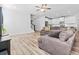 Spacious living room with hardwood floors, ceiling fan, and adjacent kitchen at 3933 Bessemer Rd, Mount Pleasant, SC 29466