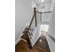 Staircase with dark wood treads, white risers, and wood railing at 3933 Bessemer Rd, Mount Pleasant, SC 29466