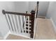 Staircase featuring dark wood treads, white risers, and wood railing at 3933 Bessemer Rd, Mount Pleasant, SC 29466