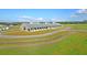 Beautiful equestrian barn featuring ample stalls and storage space surrounded by lush green pastures at 3949 Bulow Landing Rd, Ravenel, SC 29470
