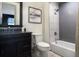 Bathroom with dark vanity, sleek fixtures, and a tiled tub-shower combo at 3949 Bulow Landing Rd, Ravenel, SC 29470