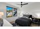 Cozy bedroom with a dark comforter set and views of the neighborhood at 3949 Bulow Landing Rd, Ravenel, SC 29470