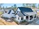 Exterior view of a modern home with a dark roof and a covered patio at 3949 Bulow Landing Rd, Ravenel, SC 29470