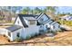 Beautiful home showcasing white siding, dark trim, and a complementing metal roof at 3949 Bulow Landing Rd, Ravenel, SC 29470