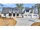 Striking two-story home with a three-car garage, enhanced by a manicured lawn and a concrete driveway at 3949 Bulow Landing Rd, Ravenel, SC 29470