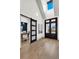 Elegant foyer featuring a barn door to an office, hardwood floors, and an attractive dark wood front door at 3949 Bulow Landing Rd, Ravenel, SC 29470