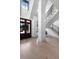 Bright foyer featuring a staircase with iron railing, hardwood floors, and a striking dark wood front door at 3949 Bulow Landing Rd, Ravenel, SC 29470