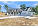 Captivating front exterior featuring a spacious three car garage and pristine driveway at 3949 Bulow Landing Rd, Ravenel, SC 29470