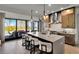 Gourmet kitchen with stainless steel appliances, island with bar seating, and access to a covered patio at 3949 Bulow Landing Rd, Ravenel, SC 29470