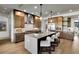 Spacious kitchen boasts a center island with seating, stainless steel appliances, and stylish pendant lighting at 3949 Bulow Landing Rd, Ravenel, SC 29470