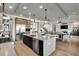 Open concept kitchen features stainless steel appliances, an island with seating, and an open floorplan at 3949 Bulow Landing Rd, Ravenel, SC 29470