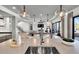 Kitchen island with a sink and seating area, seamlessly connecting to the dining area and living spaces at 3949 Bulow Landing Rd, Ravenel, SC 29470