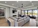 Beautiful living room features a modern fireplace, recessed lights, and floor to ceiling windows at 3949 Bulow Landing Rd, Ravenel, SC 29470